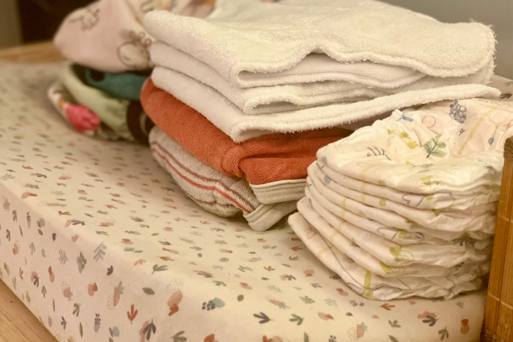 Cloth diapers and disposable diapers on changing mat 