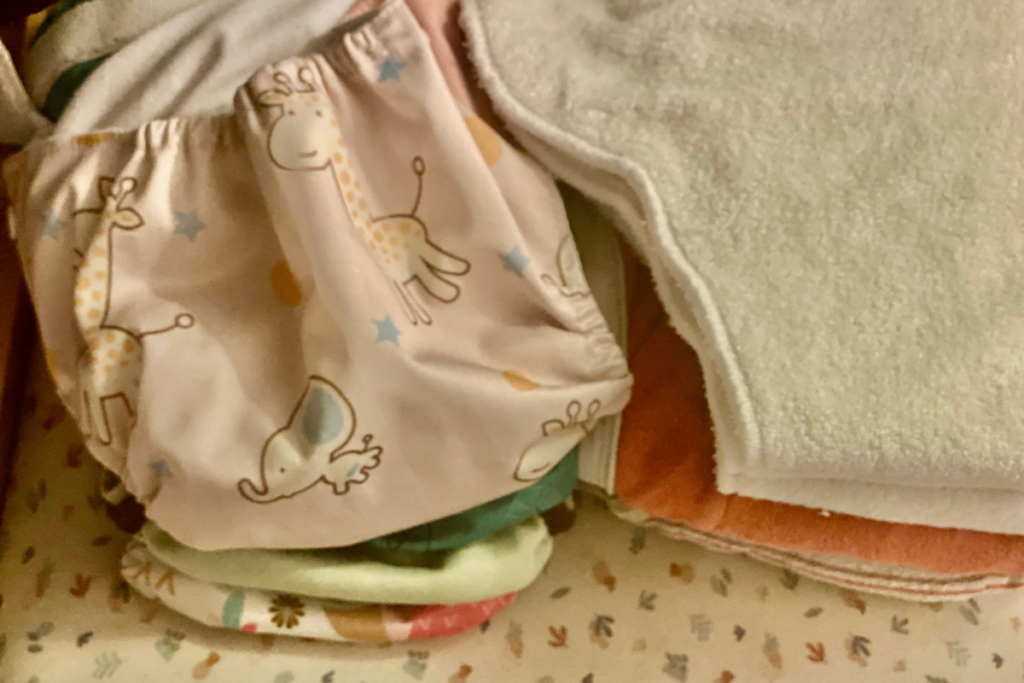 Cloth diaper covers and diapers