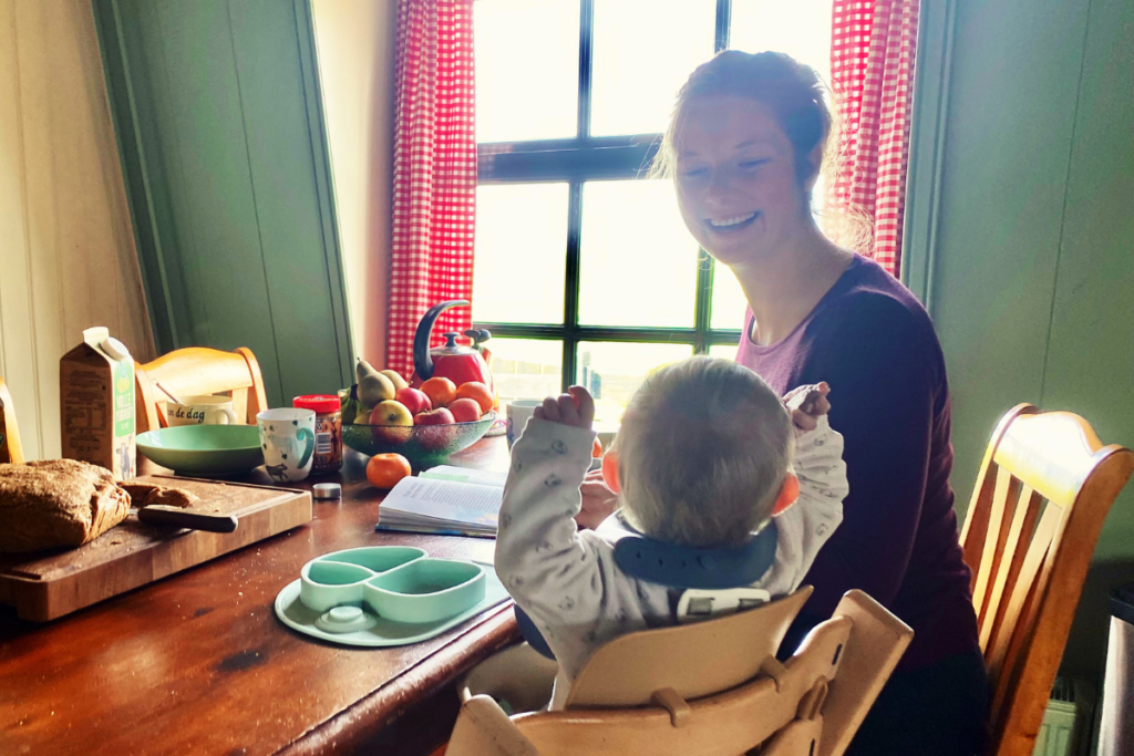 women looking at baby at a breakfast table