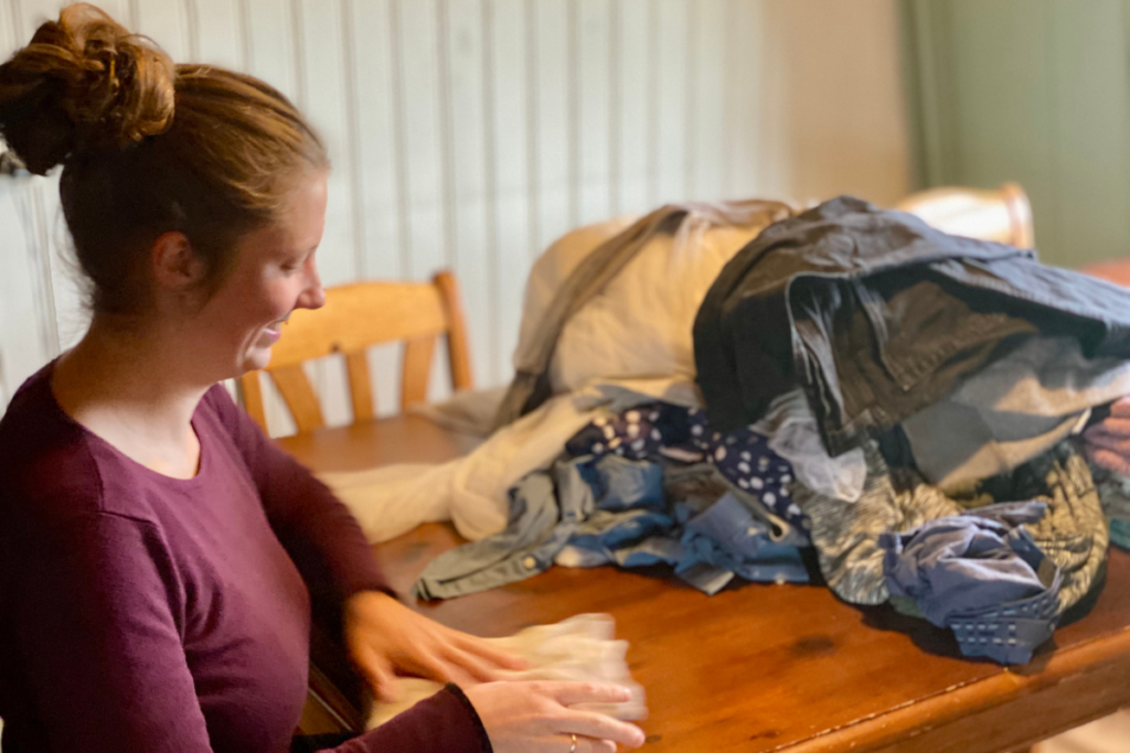 women laughing while folding laundry