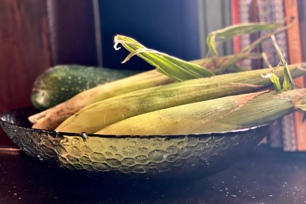 fresh sweet corn in glass fruit basket