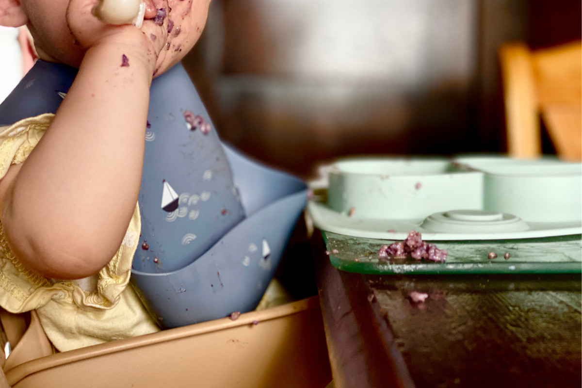 close up of baby weaning with spoon