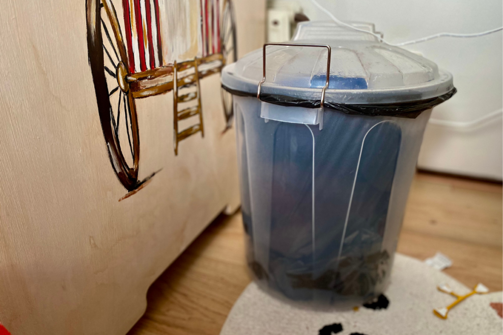 diaper pail next to baby crib