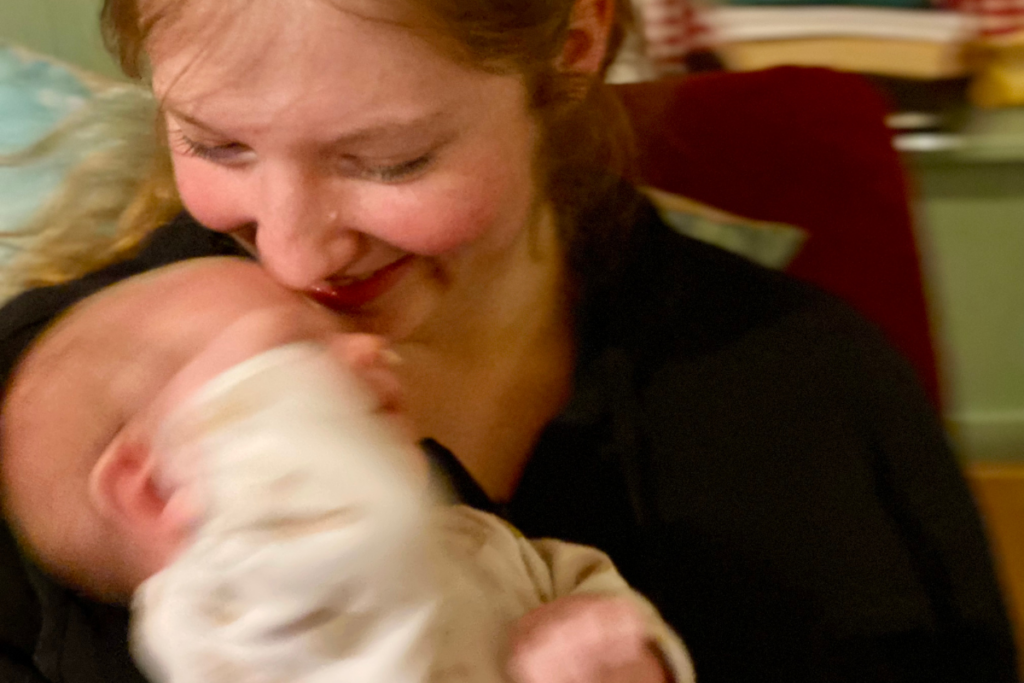 new mom holding overwhelmed newborn with focus on mother