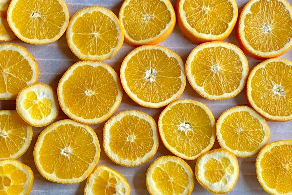 close up of orange slices on baking sheet ready to dry